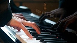 Fingers on a piano keyboard Fingers on a piano keyboard